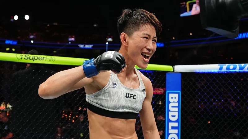 Wang Cong celebrating in the Octagon after beating Tracy Cortez at UFC 329